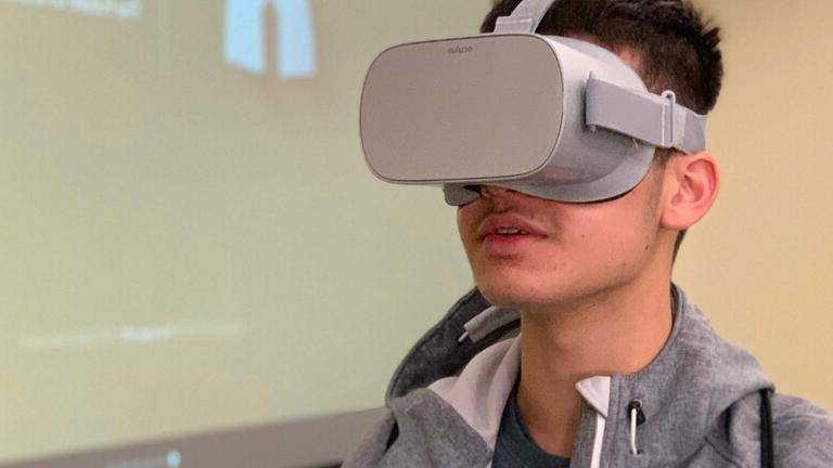 Student wearing virtual reality goggles