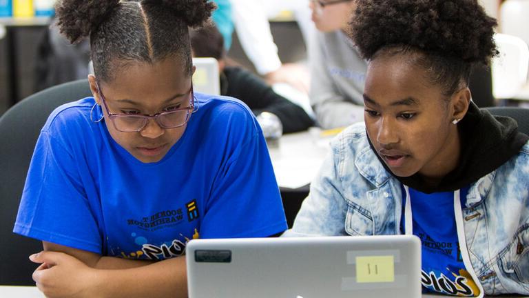 Two students in front of a computer