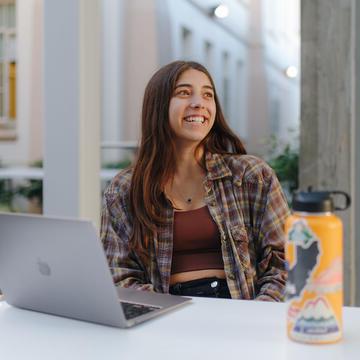 Student with a laptop studying.