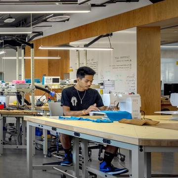 Student working at sewing machine in USF's Innovation Hive